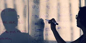 Instructor writing on whiteboard