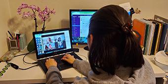 student on laptop at desk in dorm room